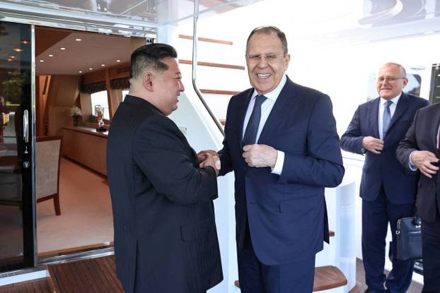 North Korean leader Kim Jong Un shakes hands with Russian Foreign Minister Sergei Lavrov during a meeting in Wonsan