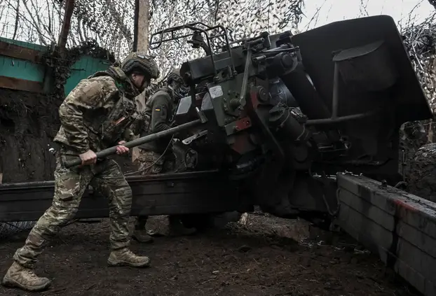 Ukrainian servicemen fire a howitzer towards Russian troops near the frontline town of Pokrovsk
