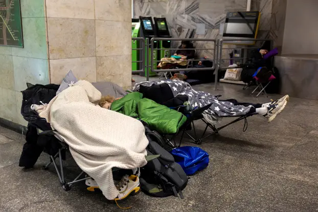 People shelter at the metro station during a Russian drone and missile attack in Kyiv