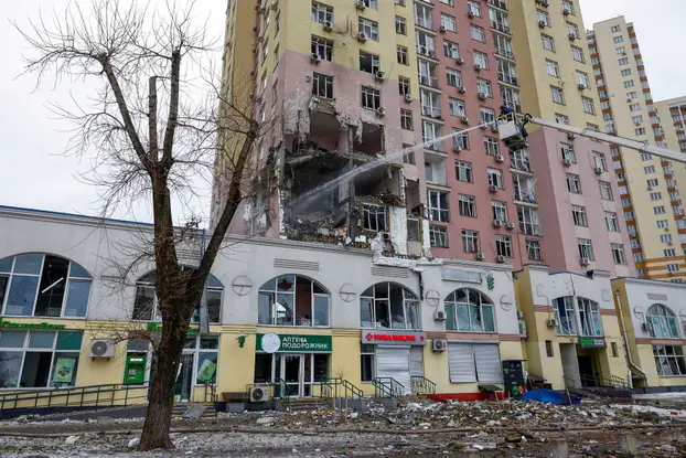 Firefighters work at the site of an apartment building hit during Russian missile and drone strikes, amid Russia’s attack on Ukraine in Kyiv,