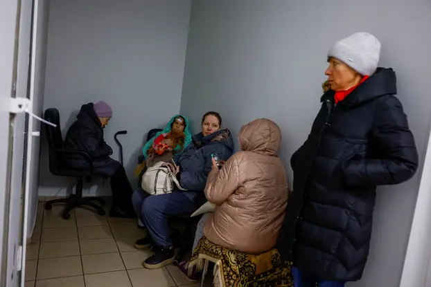 Firefighters work at the site of an apartment building hit during Russian missile and drone strikes, amid Russia’s attack on Ukraine in Kyiv