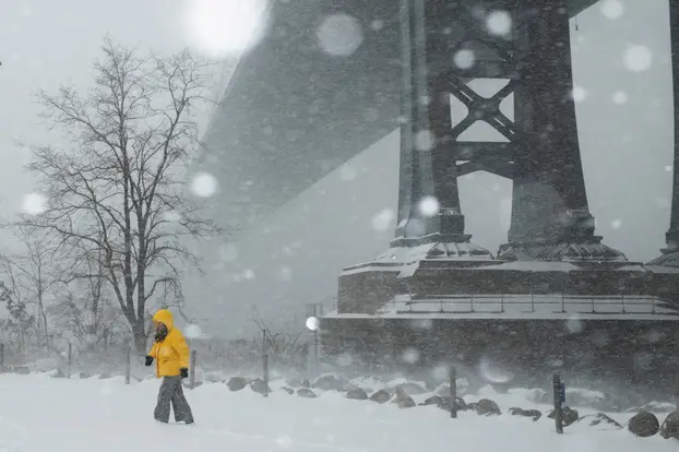 FILE PHOTO: A person walks amid a major winter storm spreading across a large swath of the United States, in Brooklyn